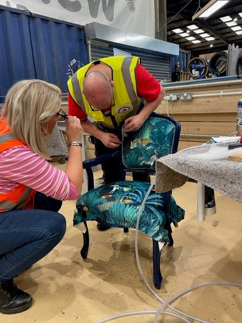 Paul from Patch Perfect showing a student how to add detail to a chair she is working on